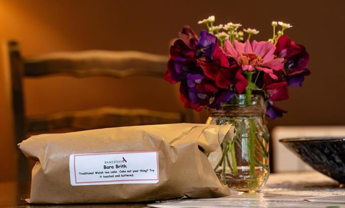 Welcome jar of flowers and home baked loaf of Bara Brith tea cake